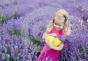 Happy little girl is in a lavender field