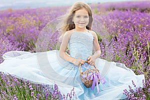 Happy little girl in lavender field with basket