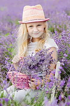 Happy little girl is in a lavender field