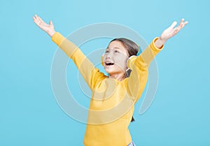 Happy little girl   listens to music in headphones