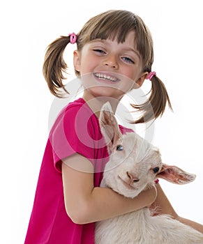 Happy little girl with little goat