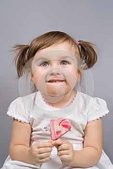 Happy little girl with lollipop