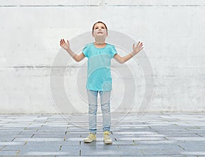 Happy little girl looking up to something