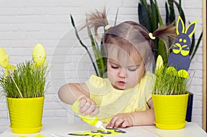 Happy little girl makes felt bunny for Easter dÃ©cor. Easter