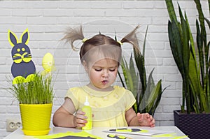 Happy little girl makes felt bunny for Easter dÃ©cor. Easter DIY.