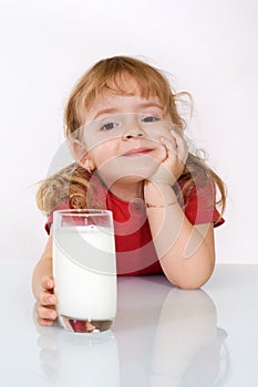 Happy little girl with milk