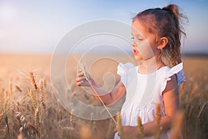Happy Little Girl Outdoor At Wheat Field. End of Summer