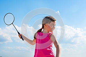 Happy little girl playing beach badminton. Family sports games on the beach. Active healthy lifestyle concept