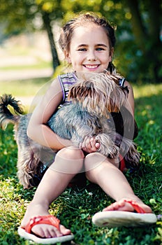 Happy little girl playing with dog