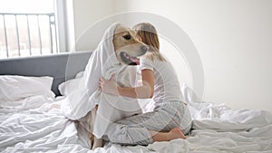 Happy Little Girl Playing With Her Pet Golden Retriever Dog, Wrapping In A Blanket