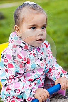 Happy little girl is playing on playground