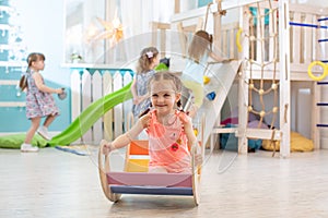 Happy little girl playing in playroom