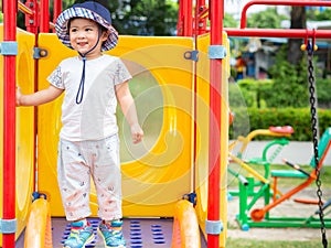 Happy little girl playing slider at the playground. Children, Ha