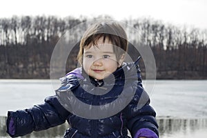 Happy little girl playing at Sumarice lake