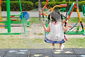 Happy little girl playing swing at the playground. Happy, Family