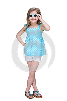 Happy little girl in a polka dot blue dress