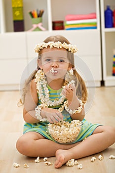Happy little girl with popcorn