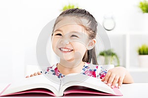 Happy little girl Reading Book