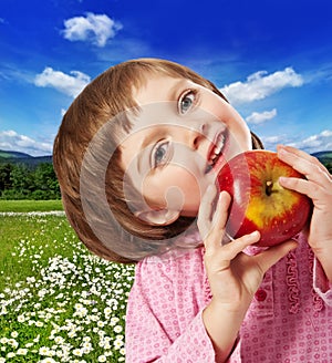 Happy little girl with red apple