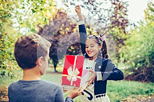 Happy little girl rejoices gift she received from her best friend