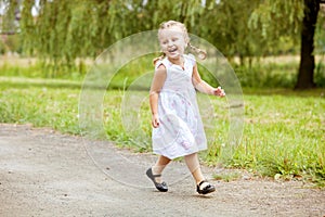 Happy little girl running on road