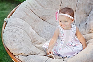 Happy little girl sitting on the couch