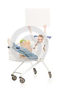 happy little girl sitting in shopping cart