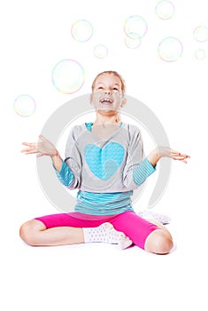 Happy little girl with soap bubbles