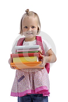 Happy little girl with stack of books and bagpack photo