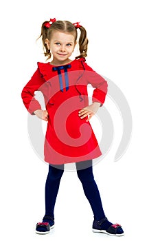 Happy little girl standing with hands on her hips