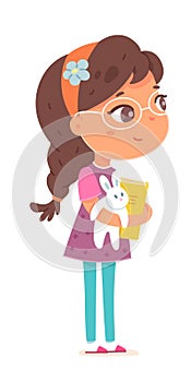 Happy little girl standing with toy and book. Joyful smiling child in glasses with cheerful face expression. Cute kid in