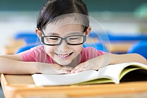 Happy little girl studying in the classroom