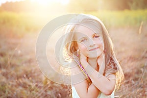 Happy little girl on summer meadow