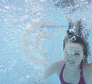 A happy little girl swimming in a pool