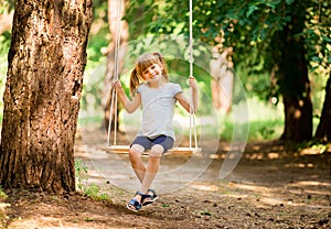 Happy Little girl on a swing in the park