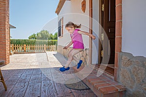 Happy little girl taking a big leap at home