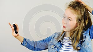 Happy little girl taking selfie.