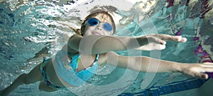 Happy little girl underwater in pool