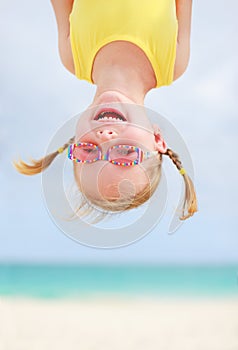Happy little girl upside down photo