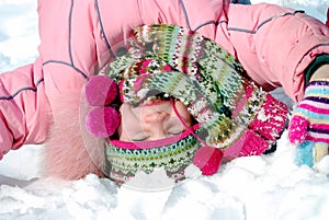 Happy little girl in winter clothing upside down