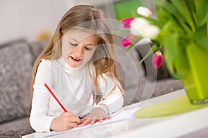 Happy little girl writing