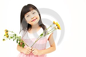 Happy little girl with yellow daisy