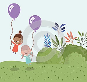 Happy little girls with balloons helium in the field landscape