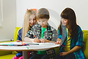 Happy Little girls and boy drawing pictures. Indoor at room