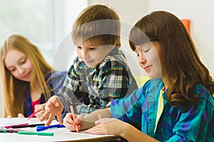 Happy Little girls and boy drawing pictures. Indoor at room