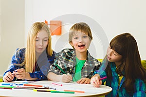 Happy Little girls and boy drawing pictures. Indoor at room