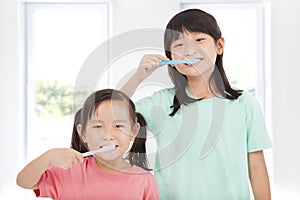 Happy little girls brushing her teeth