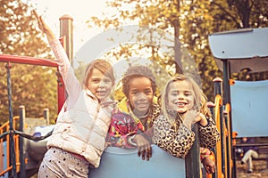 Happy little girls on playground.