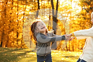 Happy little girls playing in park. Autumn walk