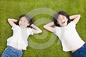 Happy Little girls resting on the grass